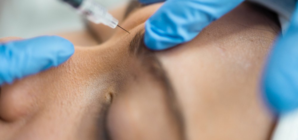 Daxxify injection being done on woman's forehead