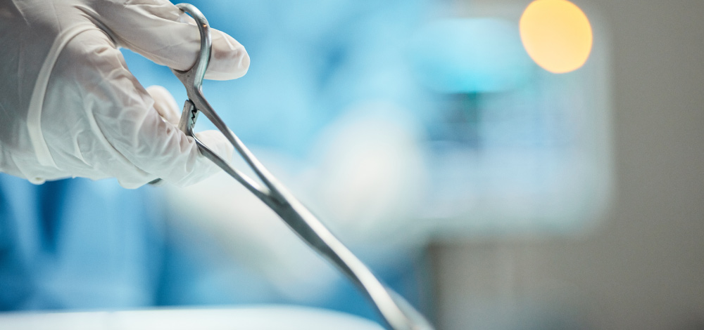 Image of dermo-surgeon holding a surgery tool