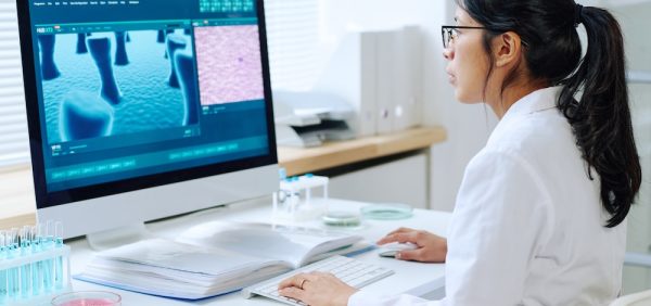 image of a young dermatologist looking into computer screen examining skin problems