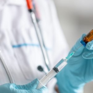 Image of doctor preparing a treatment injection