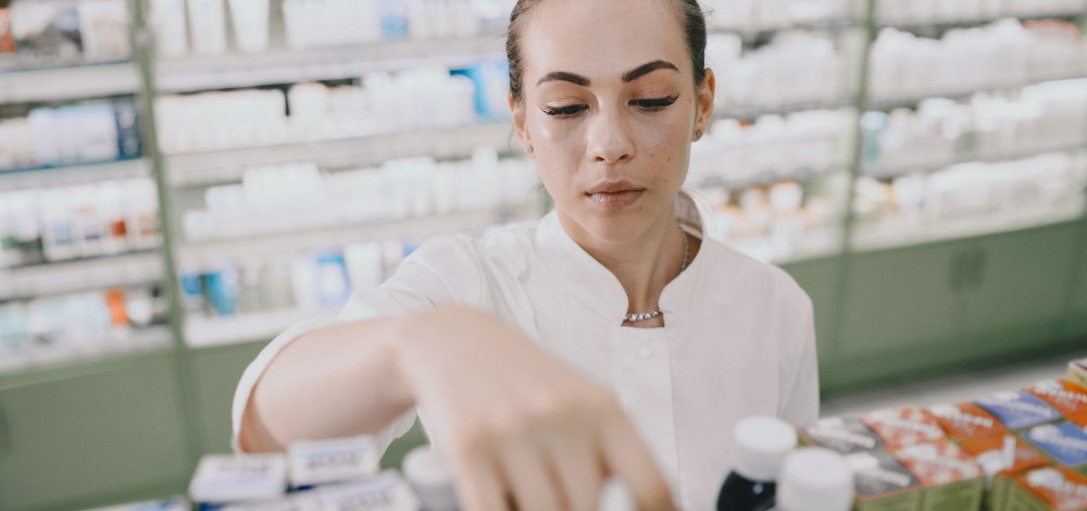 image of pharmacist looking at a shelf