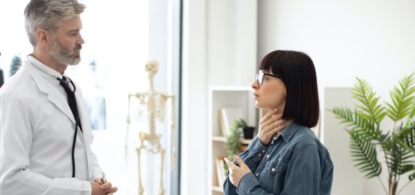 hoto of Therapist giving consultation to female patient at hospital, difficulty breating
