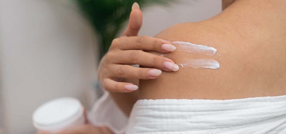 woman applying treatment cream on her skin