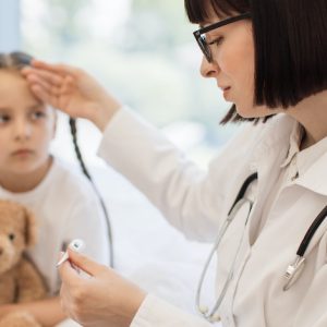 A Pediatric doctor examining a child