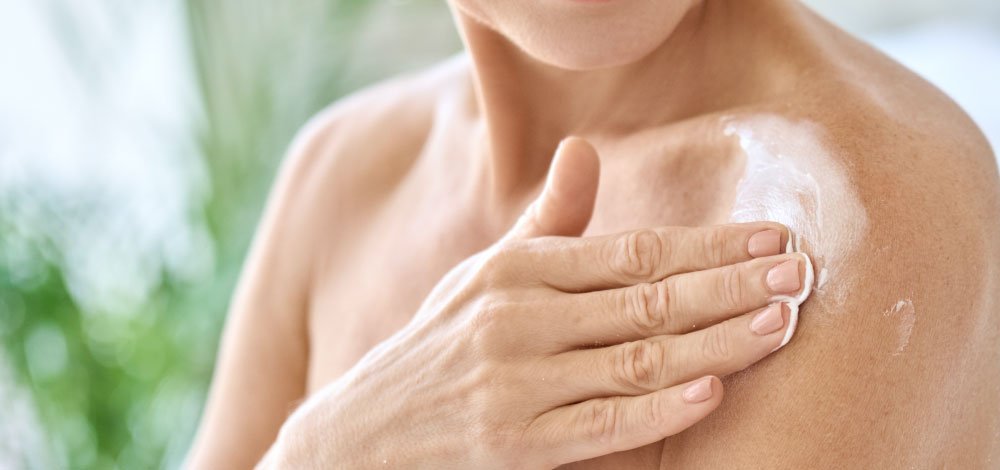 image of woman applying cream on psoriasis patch