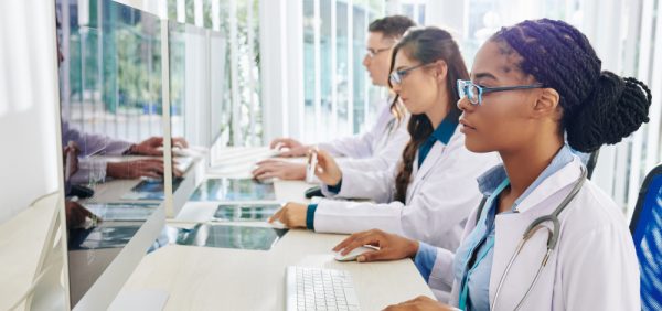 image of doctors reading STL publications on computer