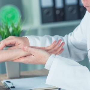 doctor looking at patient's skin