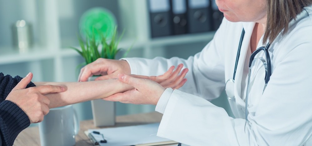 doctor looking at patient's skin