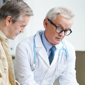image of doctor reading medical history of a patient, presumably Toxic Epidermal Necrolysis