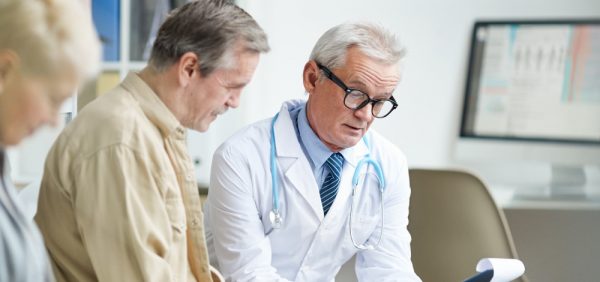 image of doctor reading medical history of a patient, presumably Toxic Epidermal Necrolysis