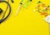 image with pills and medical devices on yellow background