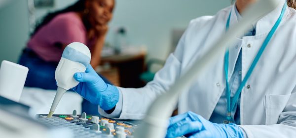 image of a doctor operating a diagnostic device