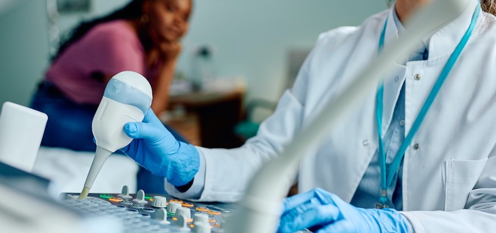 image of a doctor operating a diagnostic device
